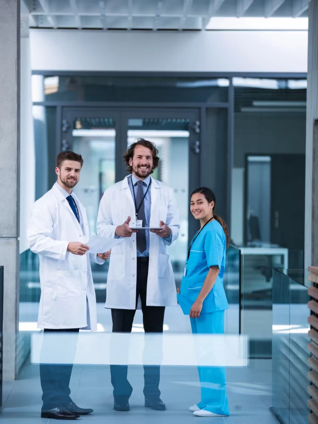 doctor-holding-digital-tablet-standing-with-colleagues